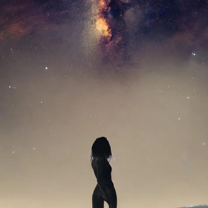 awakening - a woman looking up at the night sky to see the cosmos